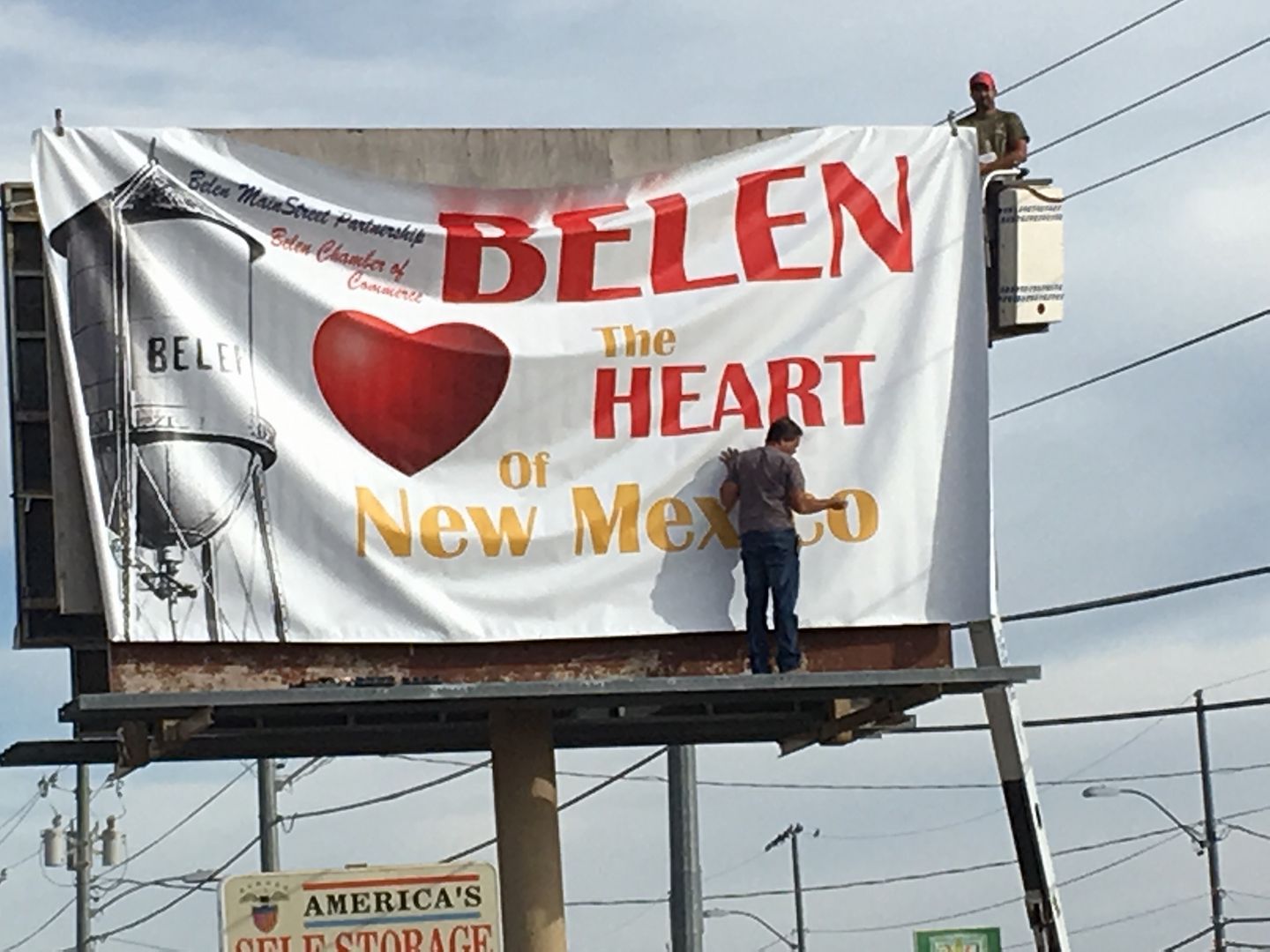 Robert putting up the 'Heart of Belen' sign